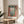 Matisse The Open Window wall art in modernist palette of coral, pale blue, and sage green, depicting a peaceful Mediterranean escape with shutters and potted greenery.