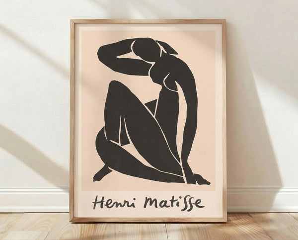 Minimalist line art framed poster of a seated female figure in black lines on cream background, evoking Matisse's elegant cut-out style.