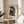 Elegant framed artwork of a seated woman rendered in minimalist black outlines and cut-out forms on warm cream paper.