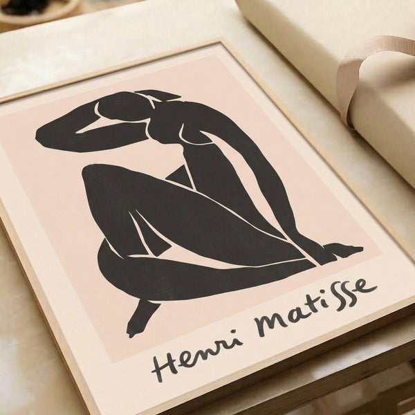 Modernist framed print featuring an elegant seated figure rendered through organic black outlines and abstract cut-paper aesthetic.