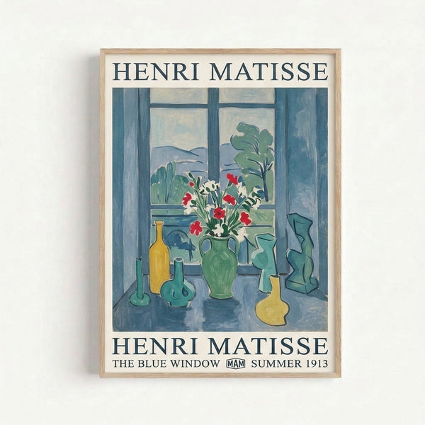 Framed art print of Matisse's The Blue Window showcasing an intimate domestic still life with blooms and greenery in cool blues and warm accents, hung on a wall.