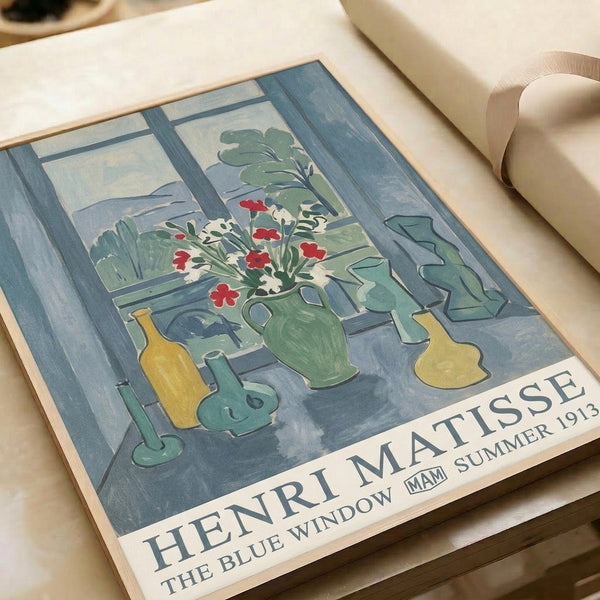 Framed reproduction of Matisse's The Blue Window featuring an airy window-focused interior with vibrant blooms and plants in teal, sage, and cream palette.