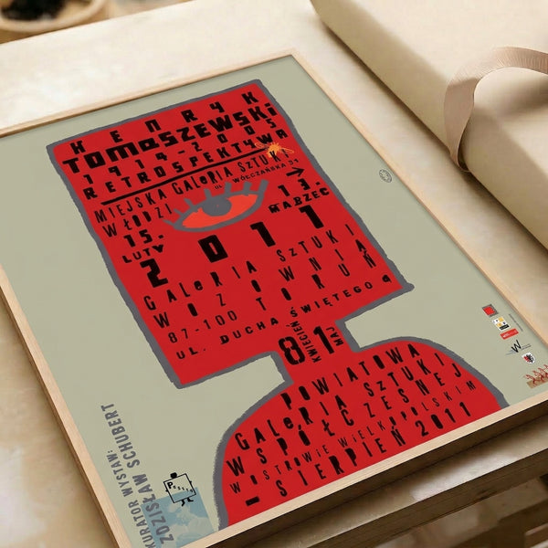 Striking graphic print with a large red eye and minimalist black typography, exemplifying the bold visual language of 1960s design movements.