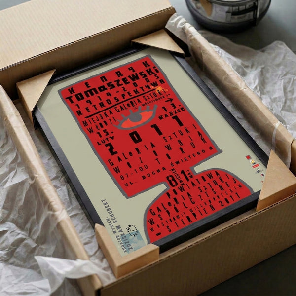 Bold exhibition poster combining a geometric red eye with industrial-style text in grayscale, framed as a statement piece of Bauhaus graphic design.