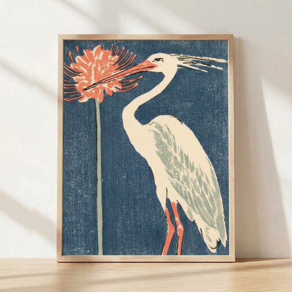 Elegant framed poster of a blue heron in Japanese woodblock style, featuring deep teal and cream tones with coral red spider lily flowers and sage green foliage.