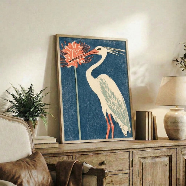 Serene art print showing a graceful heron amid blooming red spider lilies, rendered in traditional woodblock technique with rich teal, cream, and green palette.