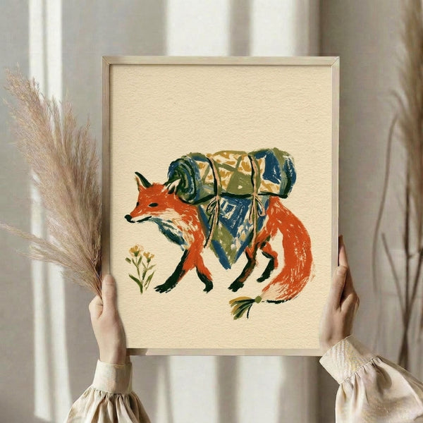 Watercolor framed poster depicting a whimsical fox traveler with bedroll surrounded by botanical elements in burnt orange, navy, and sage green cottage aesthetics.