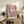 Abstract flower-inspired print on wall featuring interconnected circles and spirals in cream, mustard, and slate blue, embodying a calm and meditative spiritual quality.
