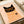 Contemporary retro poster of a quirky black cat wearing statement orange glasses, displayed as a framed minimalist wall print in cream and black.