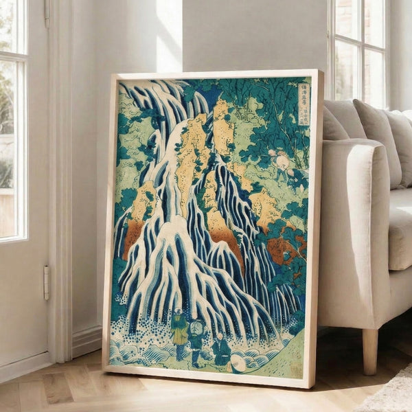 Serene Japanese mountain landscape woodblock print with a prominent waterfall, moss-covered rocks, and solitary figures in prussian blue and cream; contemplative wall art.