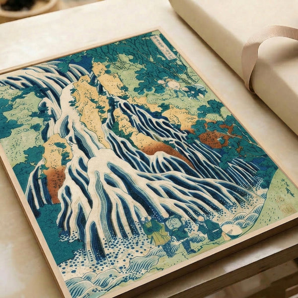 Framed traditional woodblock landscape art depicting an atmospheric waterfall cascade through mountains with teal green accents and cream highlights; serene Zen-inspired composition.