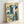 Zen landscape poster featuring a powerful waterfall, mountain terrain, and evergreen trees in cream and teal; classic Japanese woodblock aesthetic with serene, majestic atmosphere.