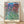 Monet impressionist watercolor poster showing a serene house nestled among blooming roses and garden flowers in soft violet, pink, and green tones.