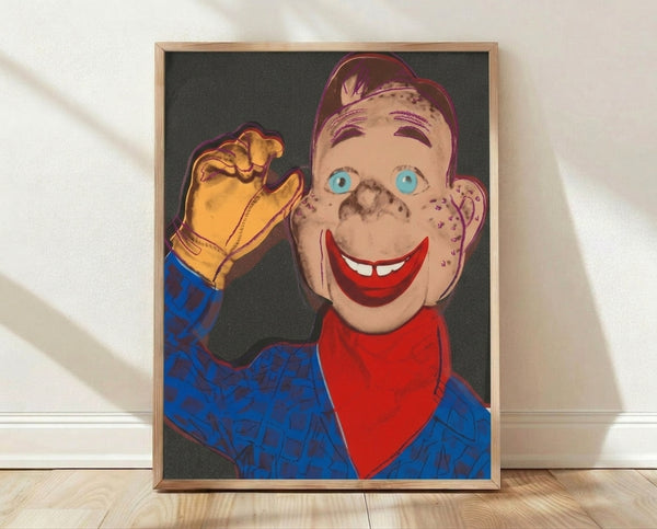 Pop art portrait of Howdy Doody with bold graphic features in black and vibrant color, framed poster on wall.