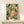 Whimsical art nouveau style poster featuring a delicate hummingbird amid lush flowers and foliage in warm coral, deep teal, and cream hues, displayed as a framed botanical print.