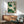 Elegant botanical wall art depicting a graceful hummingbird amid passion flowers and layered leaves rendered in watercolor with a sophisticated palette of cream and muted greens.