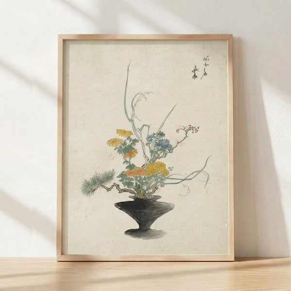 Serene Japanese woodblock-style ikebana arrangement featuring a cream ceramic vase with ochre-yellow chrysanthemums, sage green branches and leaves, rendered in refined line art with slate blue and charcoal accents, framed on wall.