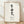 Framed minimalist poster featuring black Japanese calligraphy of Ikigai on cream background, embodying serene contemplation and purposeful simplicity.