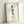Cream-toned art print with bold black brushstroke calligraphy displaying Ikigai, evoking wabi-sabi aesthetics and contemplative calm.