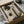 May include: Framed abstract art print featuring olive green geometric circles and vertical rectangles on cream textured background with subtle tree silhouettes, displayed in dark frame inside cardboard shipping box with protective tissue paper and bubble wrap packaging materials on white surface