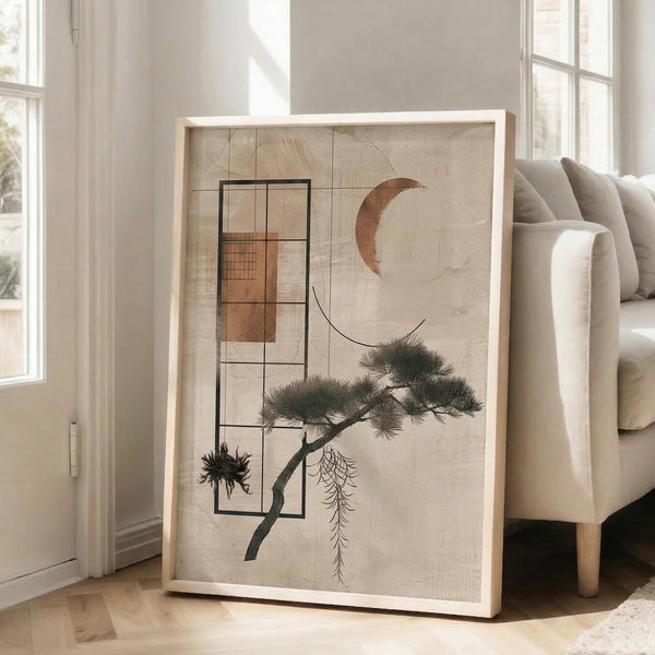May include: Large framed abstract art print leaning against white wall next to beige sofa in bright living room. Artwork features geometric black line rectangles, copper crescent moon, stylized bonsai pine tree, and textured beige background with natural wood frame.