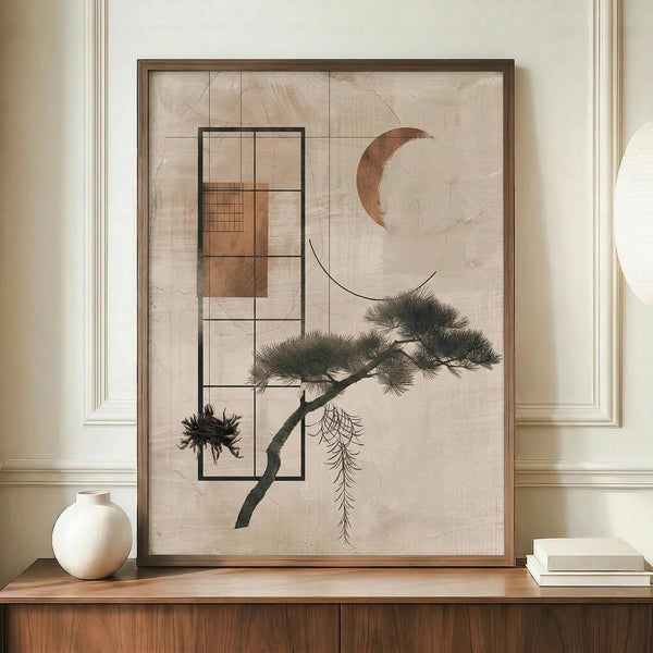 May include: Framed abstract artwork featuring geometric black rectangles overlaying a stylized pine tree branch with green needles, a copper crescent moon, and small botanical elements on textured beige background. Displayed on wooden credenza beside white ceramic vase and books in room with cream walls and white trim.