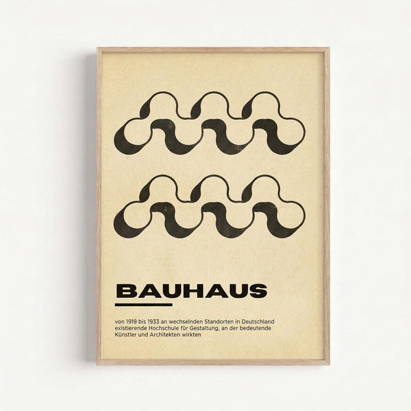Framed poster with cream background featuring two rows of black wavy interlocking chain-like patterns. Bold "BAUHAUS" text appears below the geometric design, followed by smaller German text describing the art school's history from 1919-1933. The minimalist print is displayed in a light wood frame against a white wall, showcasing the characteristic Bauhaus aesthetic of simple forms and typography.