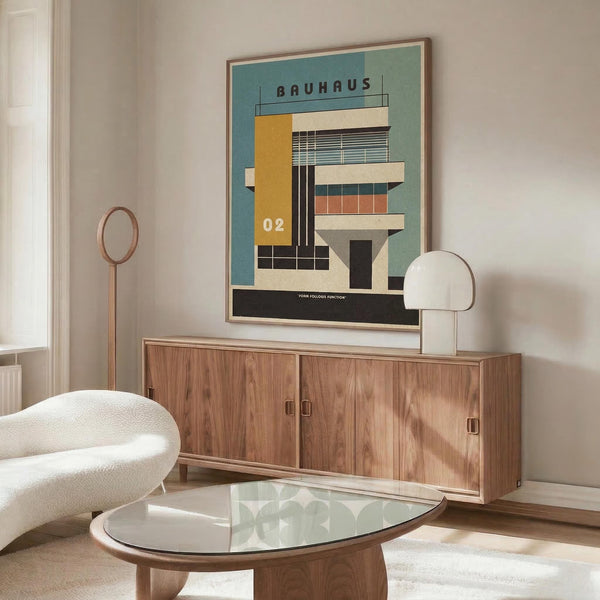 May include: Bauhaus-inspired architectural poster with geometric building design in teal, orange, and cream colors, displayed in wooden frame above mid-century modern walnut credenza. Room features white sculptural chair, glass oval coffee table, and minimalist white table lamp, creating clean Scandinavian interior styling.