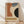May include: Framed Bauhaus-style poster with geometric shapes in terracotta, navy blue, sage green, and black against cream background, displaying "JUNE 17, 1921" and "BAUHAUS" text. Wood frame leans against white wall on light wooden floor with soft natural lighting and fabric shadows.