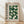 May include: Framed Bauhaus poster with green geometric semicircle pattern and German text, displayed on light wooden floor against white wall with natural shadows. The design features various shades of green circles and half-circles arranged in a grid pattern on cream background, housed in natural wood frame.