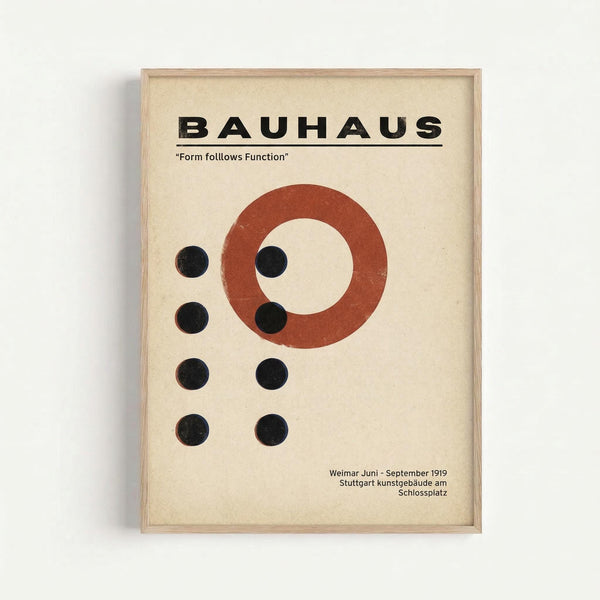 Framed vintage-style Bauhaus poster with cream background featuring bold black "BAUHAUS" text at top, red circle, and arrangement of black dots. Includes "Form follows Function" motto and German text referencing Weimar Juni-September 1919. Displayed in light wood frame against white wall with subtle shadow.
