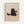 May include: Framed poster print hanging on white wall showing cute black cat illustration holding light blue mug with marshmallows, drawn in simple line art style on beige textured background with "Meow" text below, displayed in natural wood frame