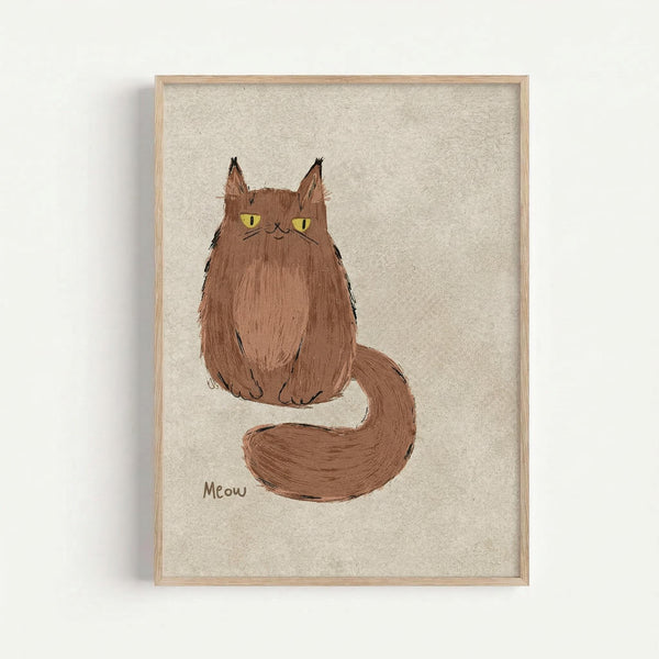 A hand-drawn illustration of a fluffy brown cat with bright yellow-green eyes sitting upright with its long bushy tail curled around. The cat has pointed ears with tufts, whiskers, and a simple facial expression. "Meow" is written in small text below the cat. The artwork is displayed in a light wooden frame against a textured cream-colored background and mounted on a white wall.