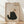 May include: Framed poster print leaning against white textured wall on light wood floor. Artwork shows black textured cat silhouette with golden eyes looking up at brown yarn ball dangling from curved string. Background has cream vintage paper texture. Word "Meow" appears in bottom left corner. Natural wood frame with warm lighting and soft shadows across scene.