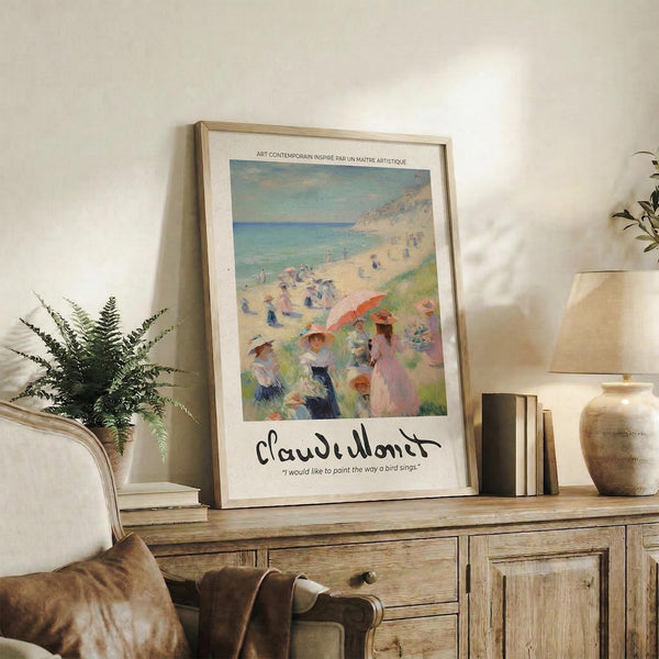 May include: Framed Monet beach scene poster with people in period dress on sandy shore, displayed on rustic wooden console table beside brown leather chair, fern plant, and ceramic vase in neutral-toned living room setting.