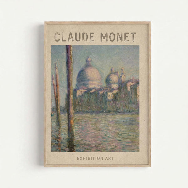 May include: Framed poster print of Monet's San Giorgio Maggiore painting displayed on white wall. The artwork shows Venice's iconic church with domed architecture across shimmering water, with wooden poles in foreground. Painted in Monet's impressionist style with soft blues, greens, and warm tones. Natural wood frame with cream matting. Text reads "CLAUDE MONET" at top and "EXHIBITION ART" at bottom.