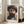 May include: Framed print of a bearded man wearing a wide-brimmed hat, painted in impressionist style with visible brushstrokes in earth tones and muted colors. The artwork is displayed in a light wood frame, leaning against a white wall next to a beige upholstered chair in a bright, minimalist room with large windows and natural lighting.