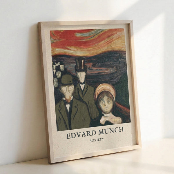 May include: Framed art print displaying Edvard Munch's expressionist painting featuring distorted figures with anxious expressions against a swirling orange and red sky. The artwork shows several people in dark clothing with pale, worried faces in Munch's characteristic style. Light wood frame sits propped against white wall with natural lighting creating soft shadows.