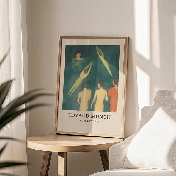 May include: Framed art print displaying swimmers in teal water with figures diving and standing on shore in yellow and coral tones, sitting on round wooden side table next to beige upholstered chair with plant shadows cast across white wall in bright natural lighting.