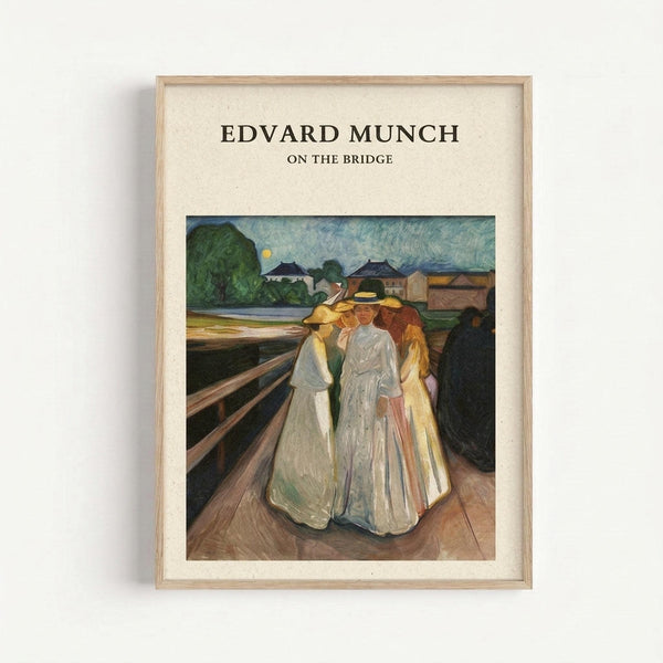 May include: Framed art print displaying Edvard Munch's expressionist painting of three figures in flowing white and yellow robes standing on a wooden bridge. The scene shows a twilight landscape with green hills, small houses, and a pale moon in a swirling blue-green sky. The print has a cream matted border in a light wood frame mounted on a white wall.