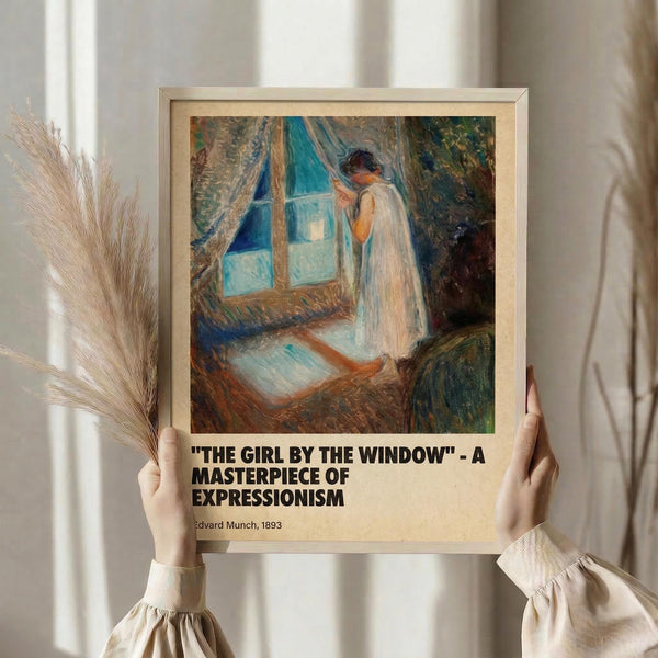 May include: Person in cream-colored clothing holding framed art print against window with sheer curtains. The artwork shows a figure in white dress standing by a blue window with curtains, painted in expressionist style with visible brushstrokes in blues, browns, and warm tones. Dried pampas grass visible on left side. Print has beige matting with black text below the image.