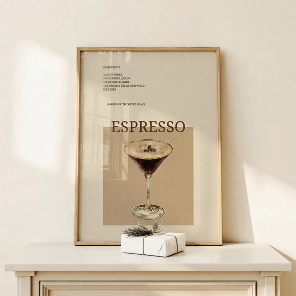 May include: Framed vintage-style espresso martini cocktail recipe poster in neutral beige tones, displayed on light wood console table against cream wall. Small white wrapped gift with twine sits beside the wooden frame. Recipe ingredients listed above illustration of dark cocktail in martini glass garnished with coffee beans.