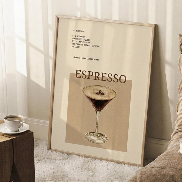 May include: Framed beige poster displaying espresso martini cocktail recipe with ingredients list including vodka, coffee liqueur, simple syrup and espresso. Shows martini glass with coffee beans floating on foam. Wooden frame leaning against white wall on textured white rug, next to wooden block with white coffee cup and beige throw blanket.