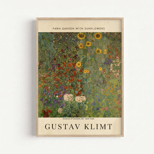 May include: Framed art print in light wood frame hanging on white wall, featuring Gustav Klimt's colorful garden painting with vibrant sunflowers, mixed wildflowers in red, purple, pink, and yellow blooms scattered across lush green foliage, museum exhibition poster style with cream colored border and black text identifying the artwork and Museum of Modern Art New York.