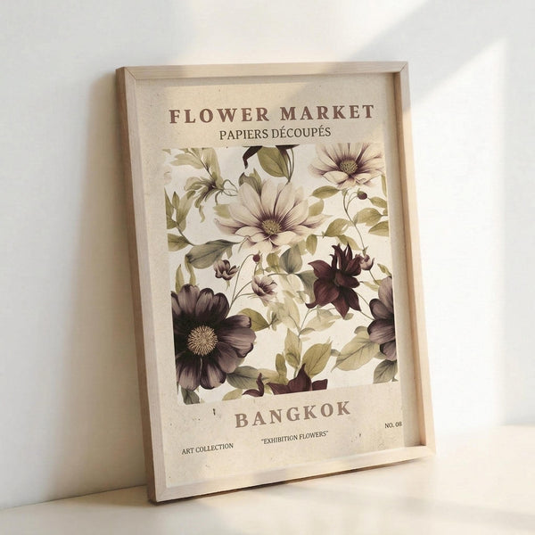 May include: Framed botanical poster print leaning against white wall showing vintage-style illustration of flowers in cream, purple, and green tones. Features large blooms with detailed leaves and stems on beige background with "FLOWER MARKET BANGKOK" text. Light wood frame casts soft shadows on neutral surface.