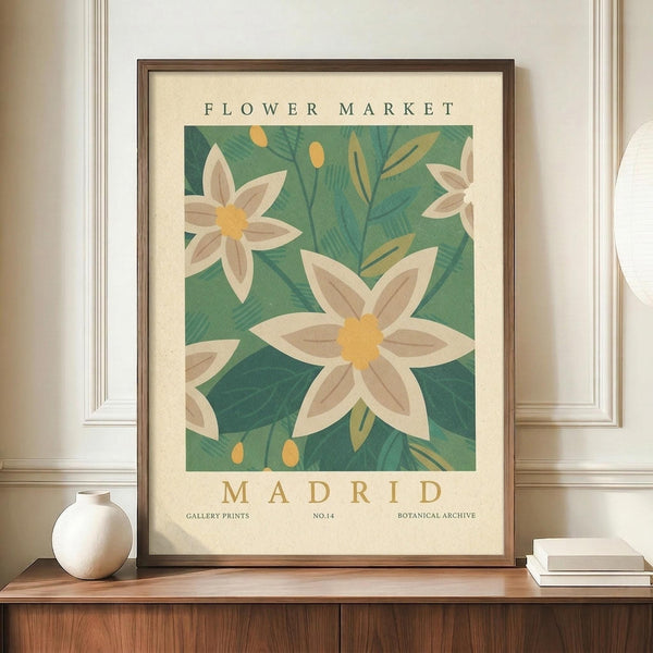 May include: Framed botanical poster with white flowers and yellow centers against green foliage background, displayed on wooden sideboard next to white ceramic vase and books in elegant room with cream walls and white molding