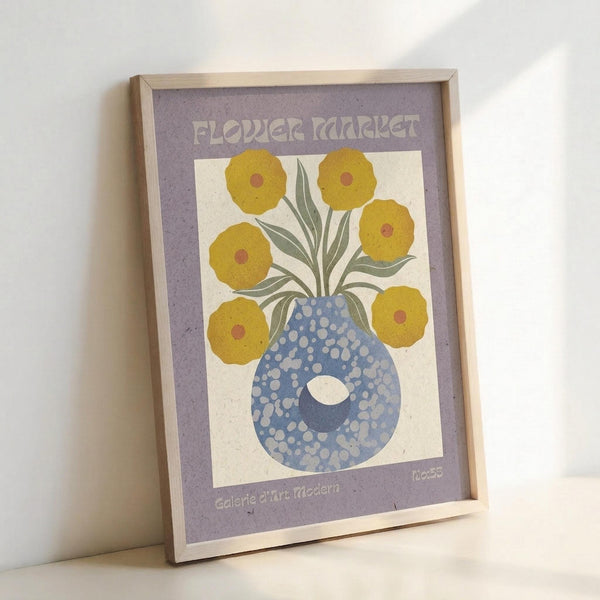 May include: Framed vintage-style botanical poster leaning against white wall showing yellow flowers with burgundy centers in blue spotted vase on cream background with purple border, displayed in natural wood frame with visible texture and grain