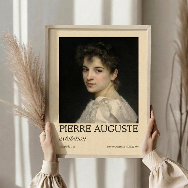 May include: Hands holding framed vintage-style exhibition poster featuring classical portrait painting of young woman with curly dark hair in white dress against black background. Cream matting surrounds artwork with "PIERRE AUGUSTE exhibition" text below. Dried pampas grass visible to left, soft neutral curtains in background create elegant room setting.