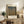 May include: Framed art print of autumn forest with tall beech trees in golden and brown tones, displayed on rustic wooden sideboard alongside fern plant, ceramic vase, stacked books, and leather chair in warm, naturally-lit living room setting