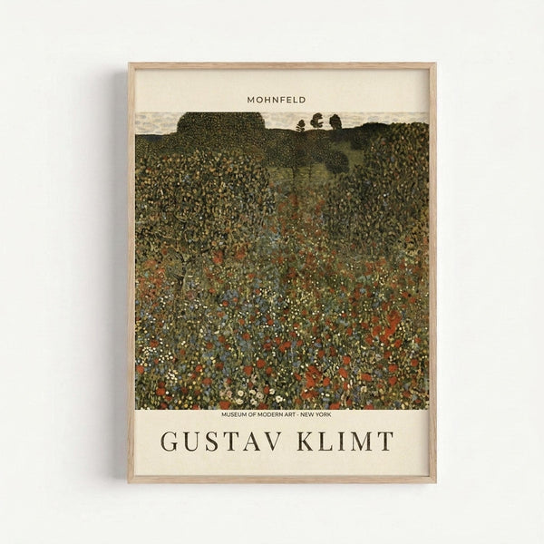 May include: Framed art print of Gustav Klimt's "Mohnfeld" showing a textured landscape with a wildflower meadow in rich greens, oranges, and whites leading to rolling hills. The poster features museum-style text at top and bottom identifying the artist and artwork. Natural wood frame against white wall background.